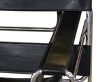 the chair is black and chrome with a black leather seat