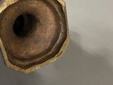 a person holding a piece of wood with a hole in it