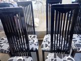 four black chairs with black and white designs on them