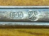a close up of a silver spoon on a table