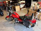 a red motorcycle that is parked in a garage