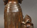 bronze statue of a woman with a dog and a cat