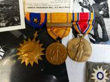 several medals are displayed on a table next to a book