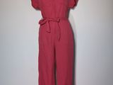 red jumpsuit with belted waist and short sleeves on a mannequin mannequin mannequin mannequin mannequin mannequin manne