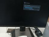 a computer monitor sitting on top of a desk next to a mouse
