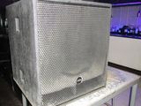 a large speaker sitting on top of a metal table
