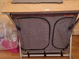 a table with a laptop on top of it in a room
