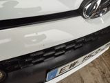 a close up of the front bumper of a white car