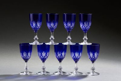 six blue glass goblets are lined up on a table