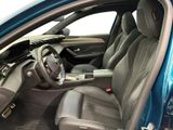 the interior of a blue car with black leather seats and a steering wheel
