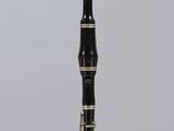 a black and gold pen sitting on top of a clear box