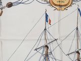 a picture of a sailboat on display on a table