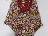 a red and yellow floral one piece swimsuit hanging on a wall