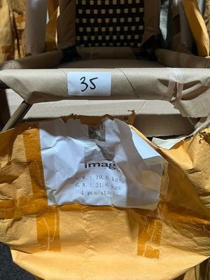 a yellow chair with a paper bag on it and a brown chair with a paper bag on the back of it