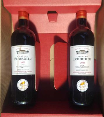 two bottles of red wine in a red box on a table