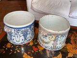 two bowls sitting on a table with a couch in the background