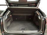 the back of a car with its trunk open and the back seats folded down