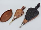 three pieces of leather and brass are sitting on a white surface
