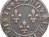 a close up of a coin with a fleur on it