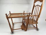 a small child ' s high chair and a table on wheels