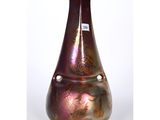 a purple vase with gold designs on it on a white background
