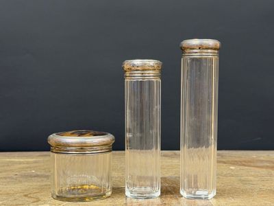 three clear glass jars with wooden lids sitting on a wooden table