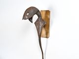 a sculpture of a bird that is on the wall