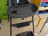 a baby high chair in the middle of a room