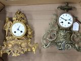 two clocks sitting in a box with tags on them