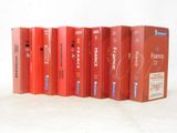 several red books are lined up in a row on a white surface