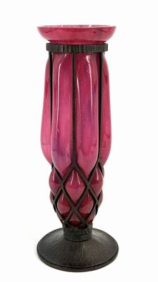 a pink vase with a black base on a white background
