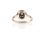 a close up of a ring with a brown diamond on it
