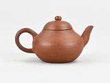 an image of a brown teapot on a white surface