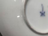 a white plate with a blue flower on it