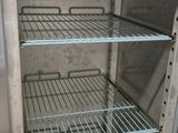 an open refrigerator with a lot of shelves inside of it