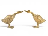 pair of brass duck figurines on a white background