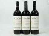 three bottles of wine sitting on top of a white table