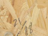 a close up of a piece of wood with a spoon and spoon rest on it