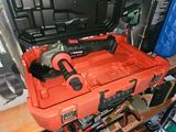 a tool box with a hammer and a drill in it