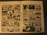 two pages from a comic book on a table