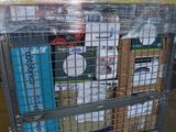 a metal cart with many items in it in a warehouse