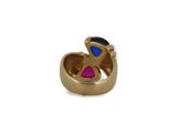 a close up of a gold ring with a pink and blue stone