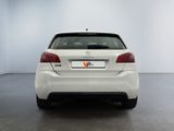 the rear end of a white car in a white room