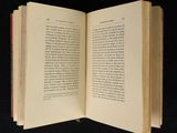 an open book on a black surface with a black background