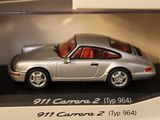 a silver toy car in a display case on a shelf
