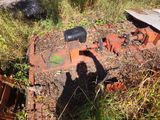 a rusted out engine sitting in the middle of a field