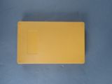 an overhead view of a yellow piece of plastic on a blue surface
