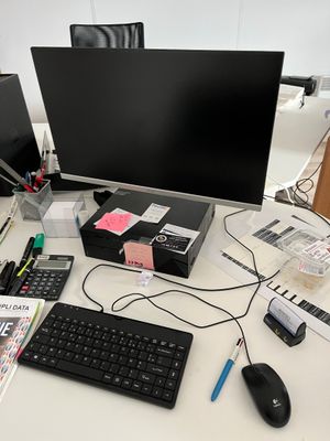 a computer desk with a keyboard, mouse, and monitor on it