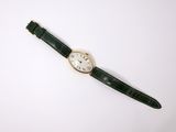 a close up of a watch on a white surface with a white background