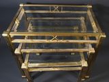 a brass and glass coffee table with three shelves